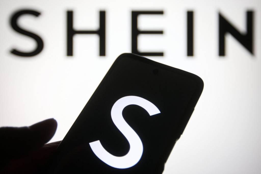 UKRAINE - 2021/08/02: In this photo illustration a Shein logo of a Chinese online fashion and sports retailer is seen on a smartphone and a pc screen. (Photo Illustration by Pavlo Gonchar/SOPA Images/LightRocket via Getty Images)