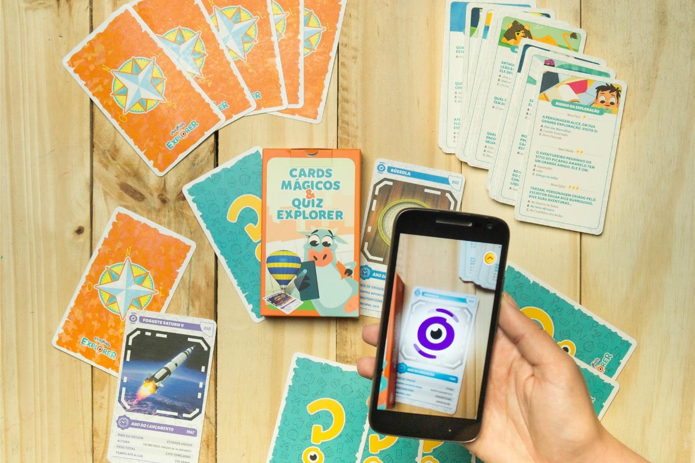 Cards mágicos do PlayKids Explorer sendo lidos por smartphone