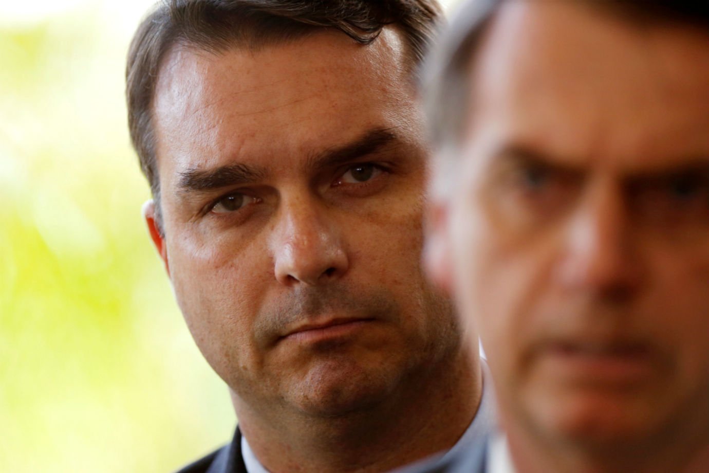 Flavio Bolsonaro, son of Brazil's President-elect Jair Bolsonaro is seen behind him at the transition government building in Brasilia, Brazil November 27, 2018. REUTERS/Adriano Machado