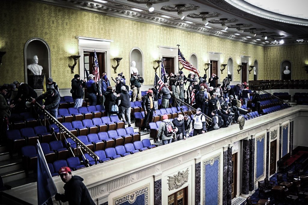 WASHINGTON, DC - JANUARY 06: Protesters enter the Senate Chamber on January 06, 2021 in Washington, DC. Congress held a joint session today to ratify President-elect Joe Biden's 306-232 Electoral College win over President Donald Trump. Pro-Trump protesters have entered the U.S. Capitol building after mass demonstrations in the nation's capital. (Photo by Win McNamee/Getty Images)