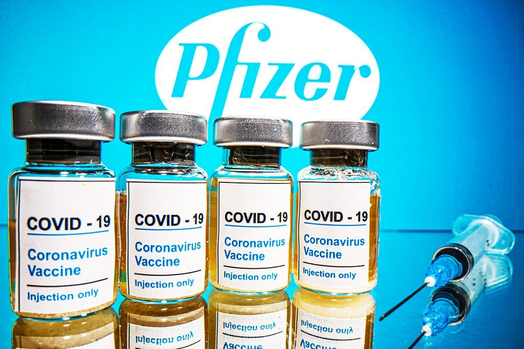 Frascos com um adesivo dizendo "COVID-19 / Vacina contra o Coronavirus / Apenas injeção" e uma seringa médica são vistos na frente de um logotipo da Pfizer exibido nesta ilustração tirada em 31 de outubro de 2020. REUTERS / Dado Ruvic