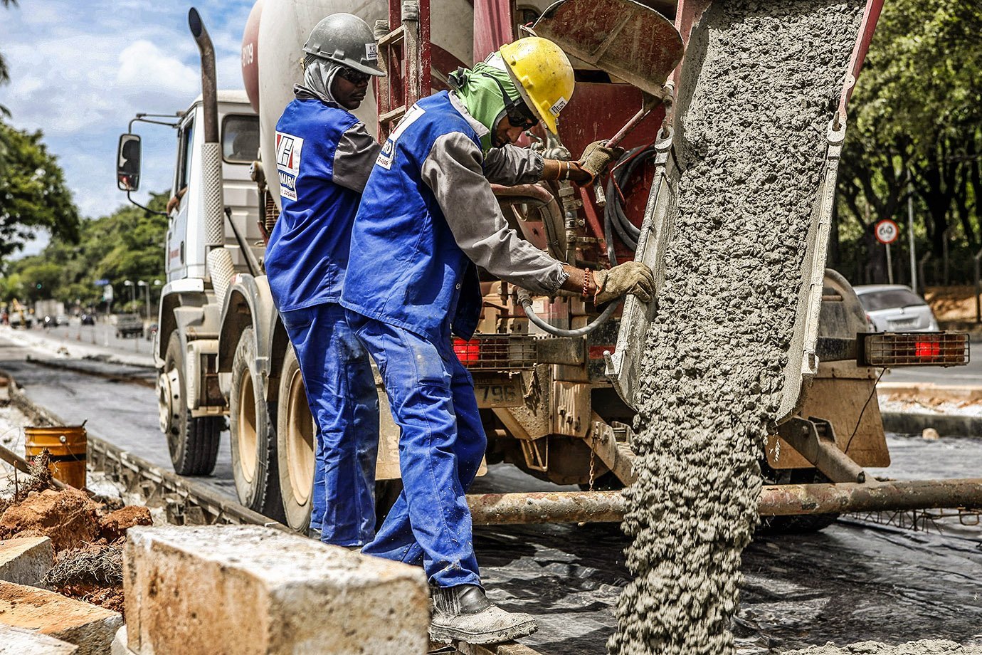 Operários trabalham com caminhão de cimento em obra | Foto: Washington Alves/Reuters